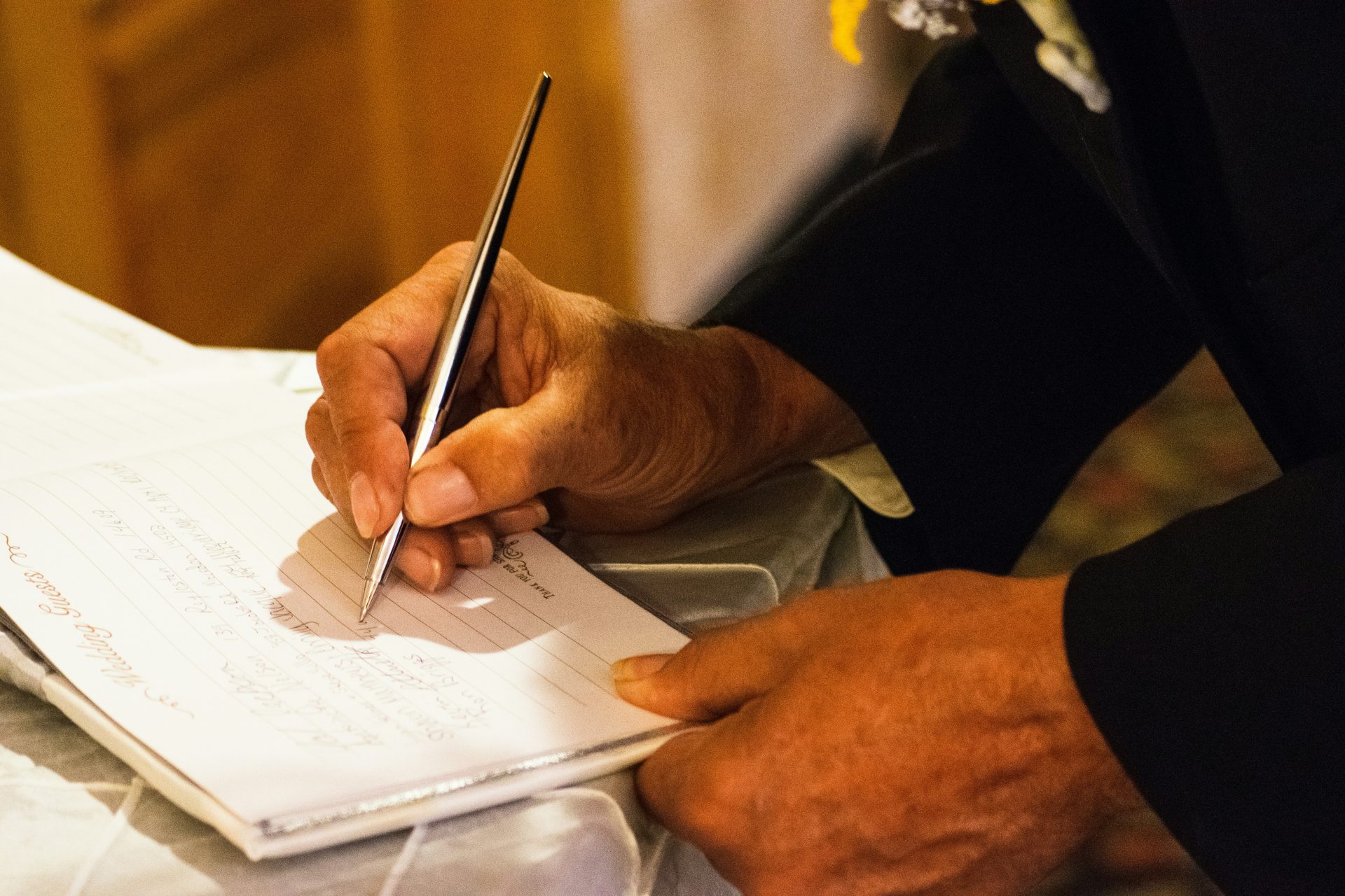person writing on notebook